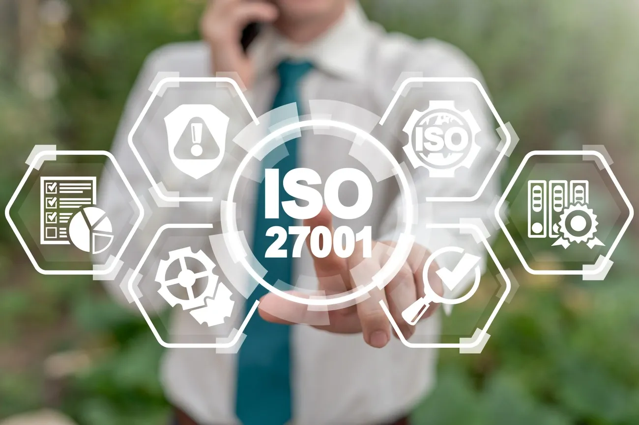 Person in business attire interacting with a virtual ISO 27001 information security management system interface.